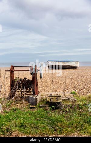 Abandoned Fishing Boat on the Beach at Aldeburgh on a February Afternoon with Very Old Rusted Winch in Foreground Stock Photo
