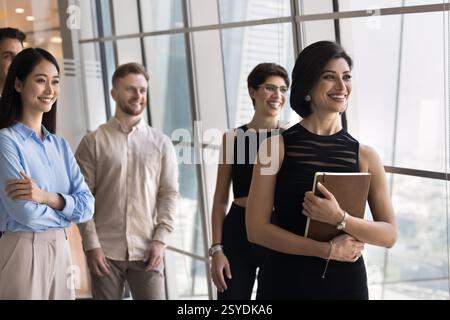 Smiling multiethnic employees with mature female boss posing at office Stock Photo