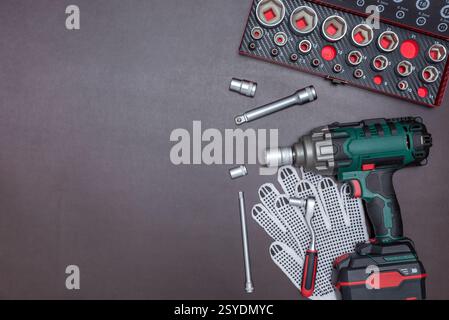 Various auto mechanic tools with cordless impact wrench on a work table. Stock Photo