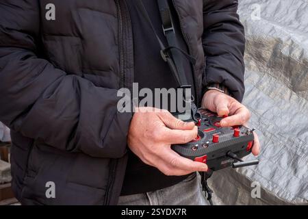 Remote control for quadcopter, close-up. Transmitter for controlling moving device in male hands, Drone remote in hand Stock Photo
