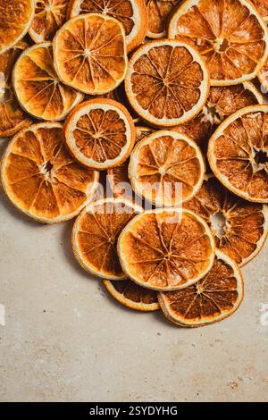A rich and textured close-up of dried orange slices, showcasing their deep amber hues, intricate details, and rustic, organic beauty. Stock Photo