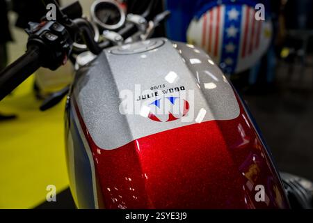 Unique motorcycle showcasing vibrant design and personalized details at auto show in bustling city environment Stock Photo
