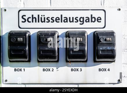 Key dispensing boxes, safes, at a small hotel, guests receive a code with which they can open the boxes and take the room key when the reception is cl Stock Photo