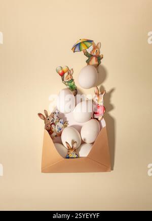 Eggs and bunnies in envelope. Creative layout, Easter card Stock Photo