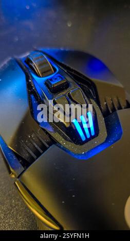 A modern wireless computer mouse sits on a white surface Stock Photo ...