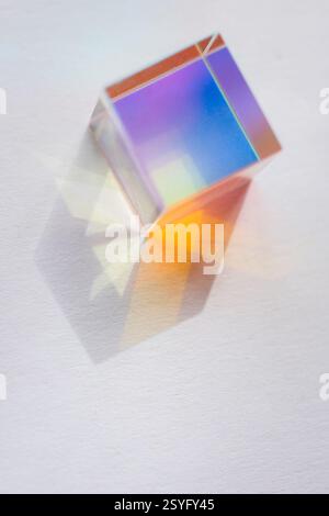 Glass cube with color spectrum rays. Abstract background with reflection and refraction of light. Stock Photo