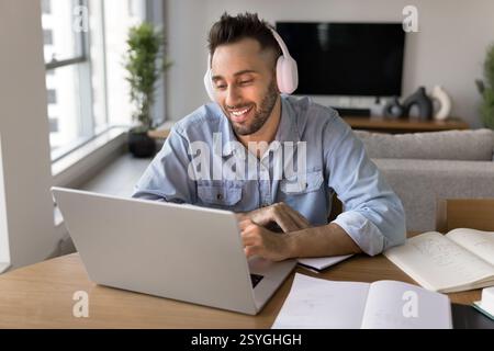 Man in headphones working or studying on laptop Stock Photo