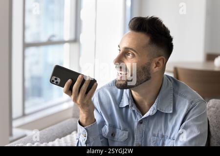 Man holding smartphone lead talk using speakerphone Stock Photo