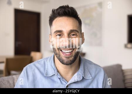 Head shot portrait of handsome Hispanic man looking at camera Stock Photo
