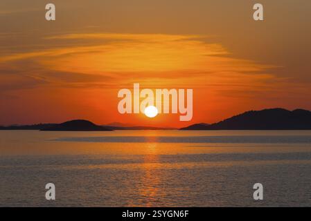 Intense red sunset over calm sea with islands, view from island Murter, Dalmatia, Croatia, Europe Stock Photo