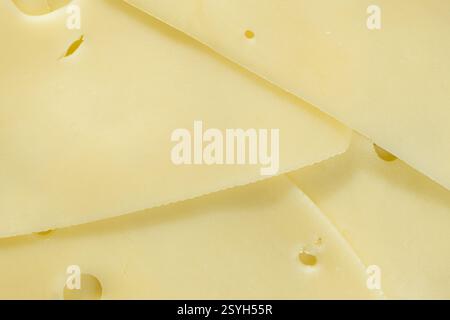 Smooth Yellow Cheese with Characteristic Holes. Stock Photo