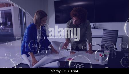 Image of 6g text over diverse colleagues discussing work in office Stock Photo