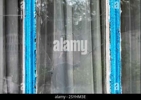 Broken glass in the window of the house. Broken glass window outside Stock Photo