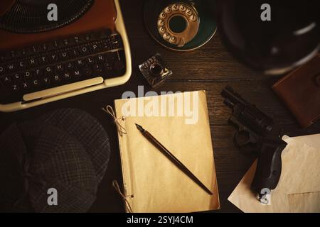 Typewriter, hat, paper, fountain pen and gun on detective's desk, flat lay Stock Photo