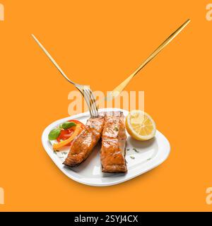 Cutlery in air over plate with tasty salmon on orange background Stock Photo