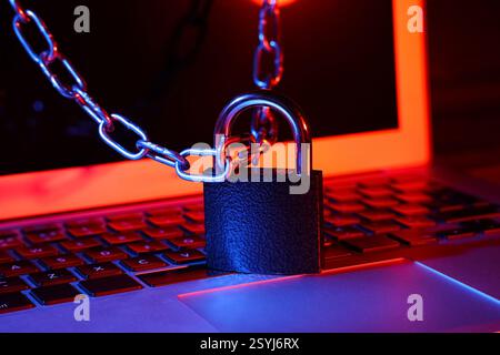 Padlock with chain on laptop, closeup. Cyber security concept Stock Photo