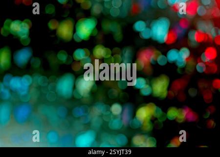 Abstrack bokeh lights, mesmerizing abstract bokeh photograph featuring vibrant circles of light in shades of green, blue, red, and yellow. Stock Photo