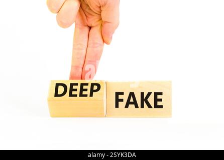 Deepfake or fake symbol. Concept words Fake Deepfake on wooden cubes. Beautiful white table white background. Businessman hand. Business and deepfake Stock Photo