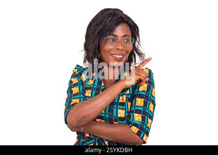 beautiful adult woman standing and pointing finger aside while smiling. Stock Photo