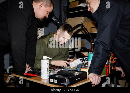 Donetsk Region, Ukraine. 18th Jan, 2025. Specialists are seen collaborating on a drone component. Engineers of the 93rd Mechanized Brigade are seen working in a drone workshop assembling and repairing critical electronic components. As modern warfare evolves, drones play an increasingly vital role enhancing reconnaissance, strike capabilities and battlefield efficiency. Their expertise directly contributes to Ukraine's defense efforts. Credit: SOPA Images Limited/Alamy Live News Stock Photo