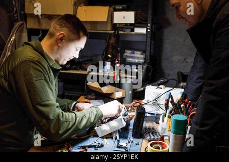 Donetsk Region, Ukraine. 18th Jan, 2025. A technician is seen inspecting the internal parts of a drone remote control. Engineers of the 93rd Mechanized Brigade are seen working in a drone workshop assembling and repairing critical electronic components. As modern warfare evolves, drones play an increasingly vital role enhancing reconnaissance, strike capabilities and battlefield efficiency. Their expertise directly contributes to Ukraine's defense efforts. (Credit Image: © Mykhaylo Palinchak/SOPA Images via ZUMA Press Wire) EDITORIAL USAGE ONLY! Not for Commercial USAGE! Stock Photo