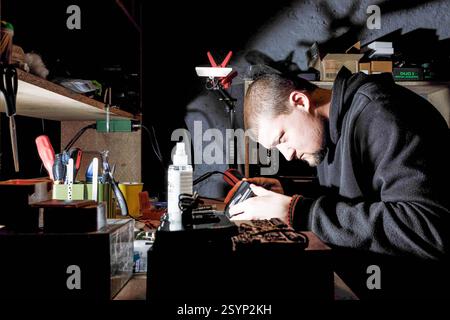 Donetsk Region, Ukraine. 18th Jan, 2025. An engineer in the 93rd Mechanized Brigade workshop focuses on assembling drone components Engineers of the 93rd Mechanized Brigade are seen working in a drone workshop assembling and repairing critical electronic components. As modern warfare evolves, drones play an increasingly vital role enhancing reconnaissance, strike capabilities and battlefield efficiency. Their expertise directly contributes to Ukraine's defense efforts. (Credit Image: © Mykhaylo Palinchak/SOPA Images via ZUMA Press Wire) EDITORIAL USAGE ONLY! Not for Commercial USAGE! Stock Photo