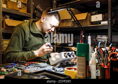Donetsk Region, Ukraine. 18th Jan, 2025. An engineer is seen working on a drone project in a workshop focused on assembling electronic components. Engineers of the 93rd Mechanized Brigade are seen working in a drone workshop assembling and repairing critical electronic components. As modern warfare evolves, drones play an increasingly vital role enhancing reconnaissance, strike capabilities and battlefield efficiency. Their expertise directly contributes to Ukraine's defense efforts. (Credit Image: © Mykhaylo Palinchak/SOPA Images via ZUMA Press Wire) EDITORIAL USAGE ONLY! Not for Commerci Stock Photo