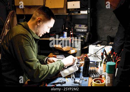 Donetsk Region, Ukraine. 18th Jan, 2025. A drone engineer is seen working on a communication module. Engineers of the 93rd Mechanized Brigade are seen working in a drone workshop assembling and repairing critical electronic components. As modern warfare evolves, drones play an increasingly vital role enhancing reconnaissance, strike capabilities and battlefield efficiency. Their expertise directly contributes to Ukraine's defense efforts. (Credit Image: © Mykhaylo Palinchak/SOPA Images via ZUMA Press Wire) EDITORIAL USAGE ONLY! Not for Commercial USAGE! Stock Photo