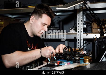 Donetsk Region, Ukraine. 18th Jan, 2025. A technician repairs an electronic drone device at his workstation. Engineers of the 93rd Mechanized Brigade are seen working in a drone workshop assembling and repairing critical electronic components. As modern warfare evolves, drones play an increasingly vital role enhancing reconnaissance, strike capabilities and battlefield efficiency. Their expertise directly contributes to Ukraine's defense efforts. (Credit Image: © Mykhaylo Palinchak/SOPA Images via ZUMA Press Wire) EDITORIAL USAGE ONLY! Not for Commercial USAGE! Stock Photo