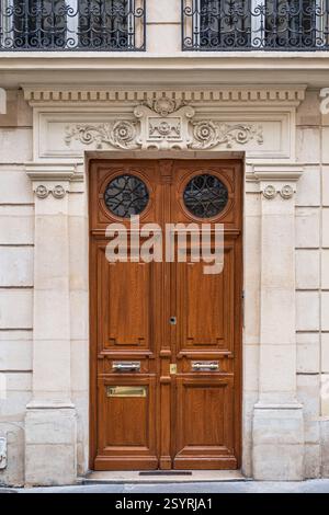 Detail of the exterior architecture of the door, window and balcony of an old building in Paris, France Stock Photo