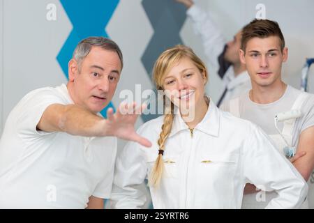 painter with apprentice and client Stock Photo