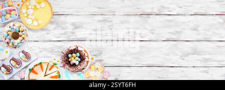 Easter or spring dessert food corner border. Overhead view on a white wood banner background. Lemon tart, cupcakes, Easter egg and carrot cakes and a Stock Photo