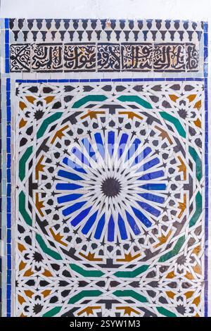 close-up of a vibrant tile mosaic with a mesmerizing geometric pattern in shades of blue, green, and yellow, creating a visually stunning and cultural Stock Photo