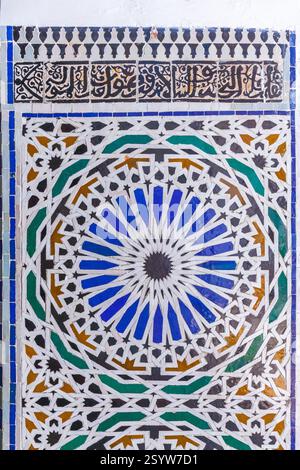 close-up of a vibrant tile mosaic with a mesmerizing geometric pattern in shades of blue, green, and yellow, creating a visually stunning and cultural Stock Photo