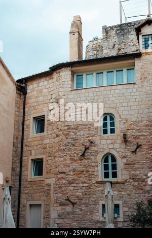 Historic stone building with arched windows in a European old town. Split, Croatia. Stock Photo
