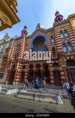 A vibrant beach scene on a sunny day, featuring people engaged in various activities with a calm sea and distant, Jerusalem synagogue, Jerusalem synag Stock Photo