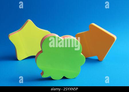 Green speech bubble, orange arrow and yellow star, colorful sticky notes Stock Photo