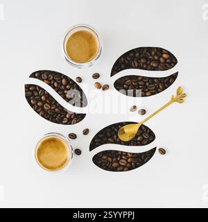 Creative layout made with coffee beans visible through a coffee beans shaped gaps and two cups of coffees on white background. Minimal concept. Stock Photo