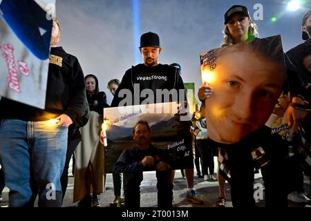 Oct. 1, 2023, Las Vegas, Nevada, USA : A moment of silence is had while people display photographs of victims from the 2017 Las Vegas mass shooting near the venue in Las Vegas. About 150 people braved rain and cold wind at the former Las Vegas Village to honor and remember the 58 people who were killed six years ago by a lone gunman during the Route 91 Harvest Music Festival from the 32nd story of Mandalay Bay Resort and Casino on October 1, 2017. Fifty-eight people died initially with two additional people dying later due to their injuries, making the incident the deadliest mass shooting by a Stock Photo