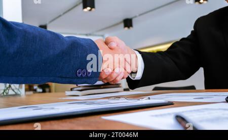 Businessman shaking hands successful making a deal. mans handshake. Business partnership meeting concept. Stock Photo