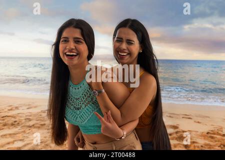 Two female friends having fun on the beach Stock Photo