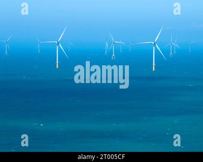 Offshore Windmill farm in the ocean Stock Photo