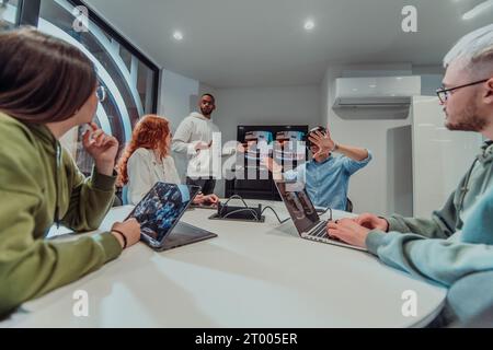 A diverse group of businessmen collaborates and tests a new virtual reality technology, wearing virtual glasses, showcasing inno Stock Photo