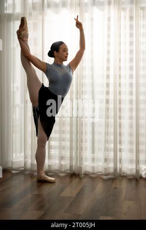 Young ballerina dancing and practicing her movement at home before the show. Tiptoe movements. Concept of classic ballet Stock Photo