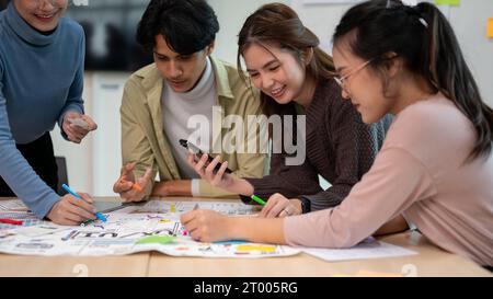 Team of young professional UX/UI designer working together in the meeting room, preparing for the next project. UX/UI concept. Stock Photo