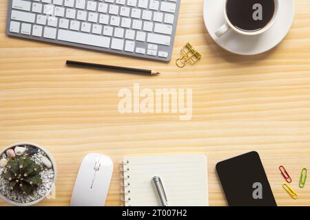 wood desk office with laptop, smartphone and other work supplies with cup of coffee. Top view with copy space for input the text. Designer workspace o Stock Photo