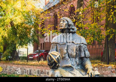 Olsztyn Poland - October 2022 Planet in hand of Nicolaus Copernicus statue near his famous castle. Nicolaus Copernicus statue on Stock Photo