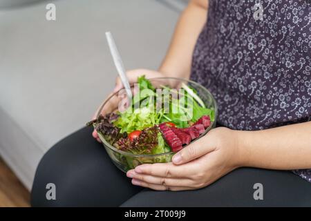 Asian Overweight woman dieting Weight loss eating fresh fresh homemade salad healthy eating concept Obese Woman with weight diet Stock Photo