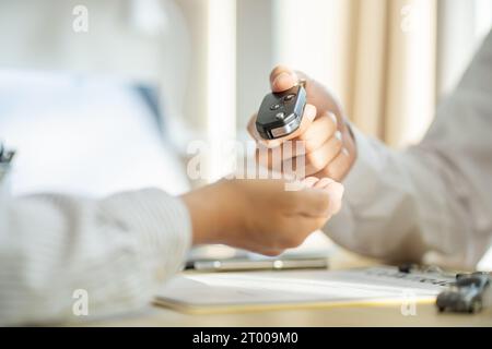 Loss Adjuster Insurance Agent Inspecting Damaged Car.  Sales manager giving advice application form document considering mortgag Stock Photo