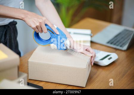 Asian woman preparing package delivery box Shipping for shopping online delivery mail service people and shipment concept Stock Photo
